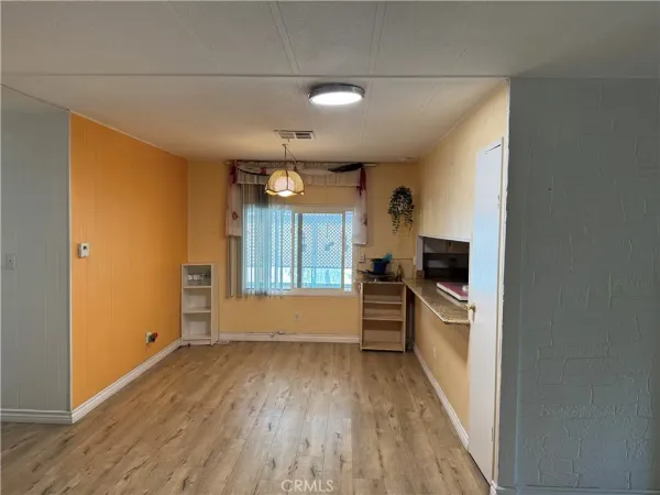 a view of a kitchen and dining room with wooden floor