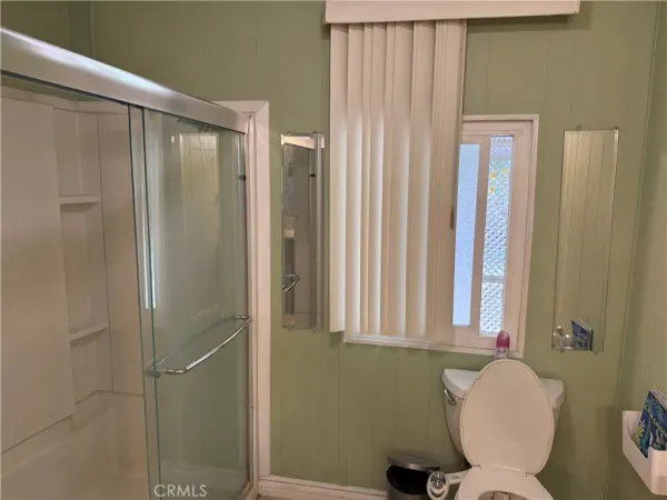 a bathroom with a toilet and a shower