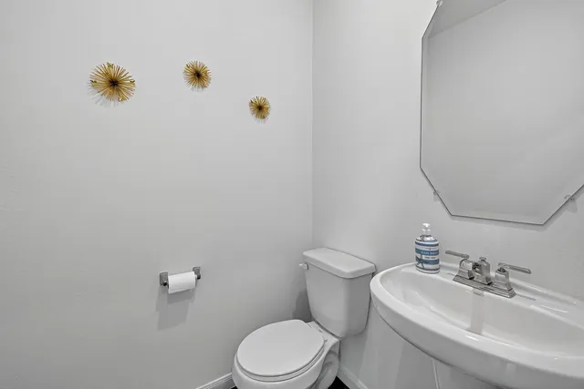 a white toilet sitting next to a bathroom sink