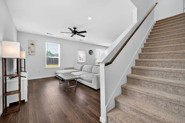 a view of entryway and hall with wooden floor