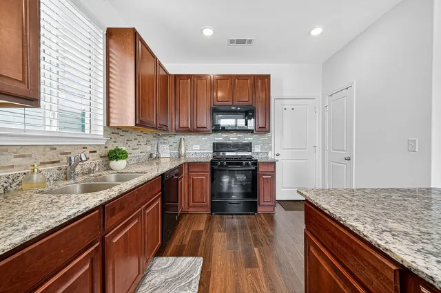 a kitchen with a sink stove and refrigerator