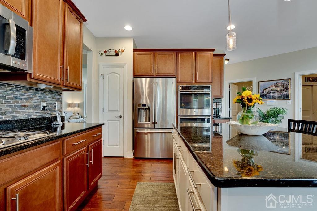 339 Ticetown Road Old Bridge, NJ 08857 - Photo 13 of 44 a kitchen with stainless steel appliances granite countertop a refrigerator and a stove