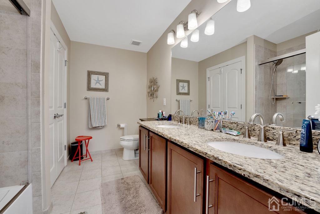 339 Ticetown Road Old Bridge, NJ 08857 - Photo 32 of 44 a bathroom with a granite countertop double vanity sink and a mirror