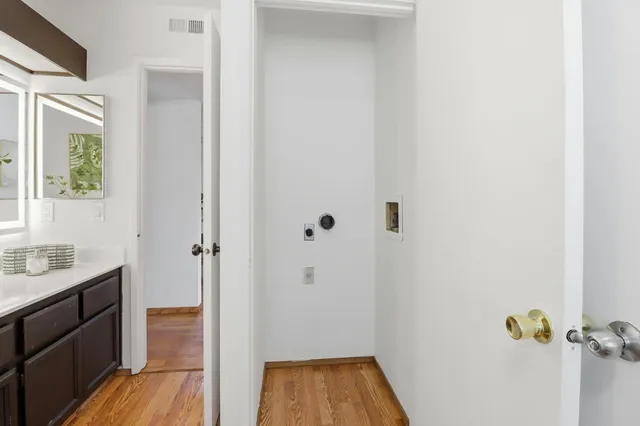 a bathroom with a granite countertop sink toilet and mirror