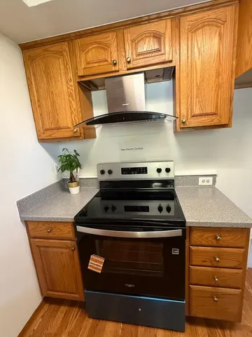 a stove top oven sitting inside of a kitchen