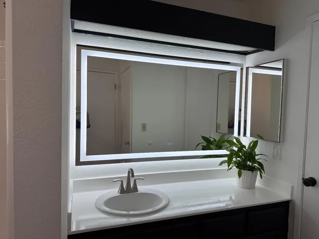 a bathroom with a sink and a mirror