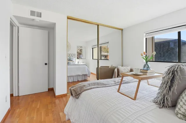 a bedroom with a bed and painting on the wall