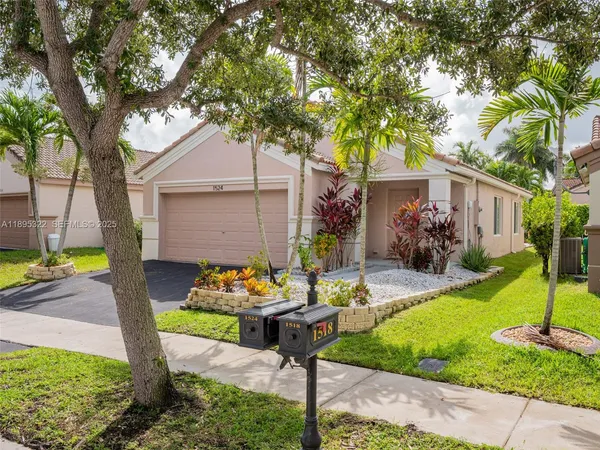 a front view of house with yard and outdoor seating