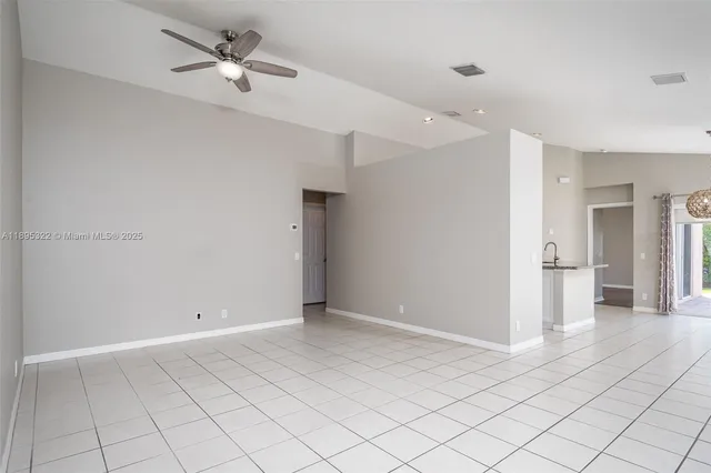 a view of a livingroom with a ceiling fan and entryway