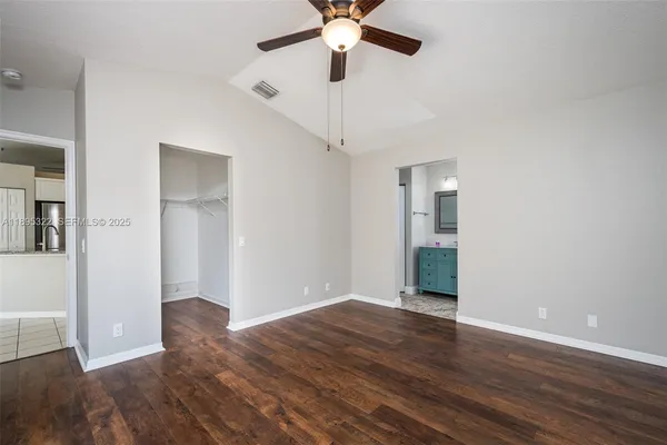 a view of an empty room with wooden floor