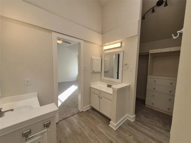 a bathroom with a sink a mirror and a shower