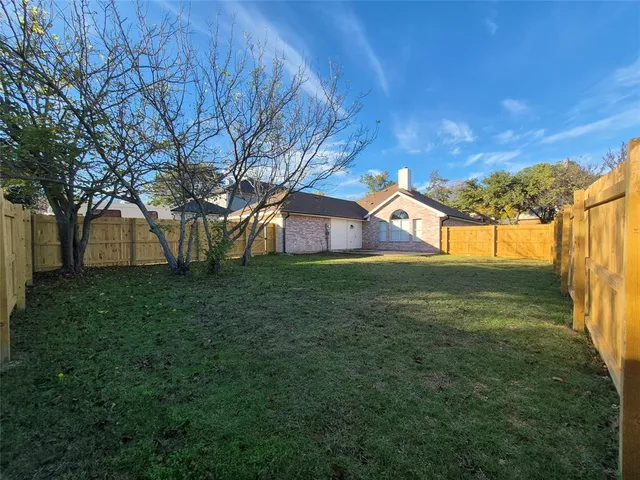 a view of a house with a backyard