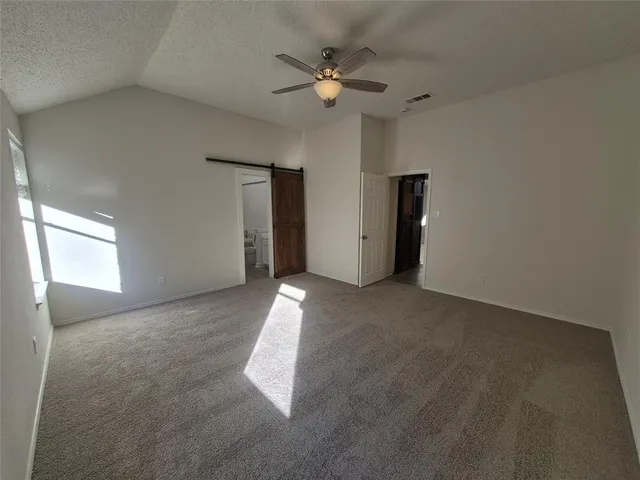 a view of a livingroom with a ceiling fan and window