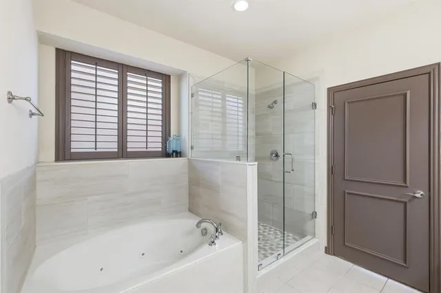 a bathroom with a bathtub and a shower