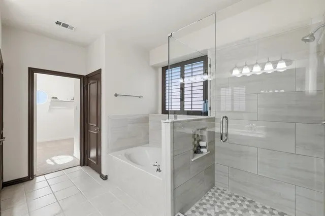 a bathroom with a bathtub and a shower