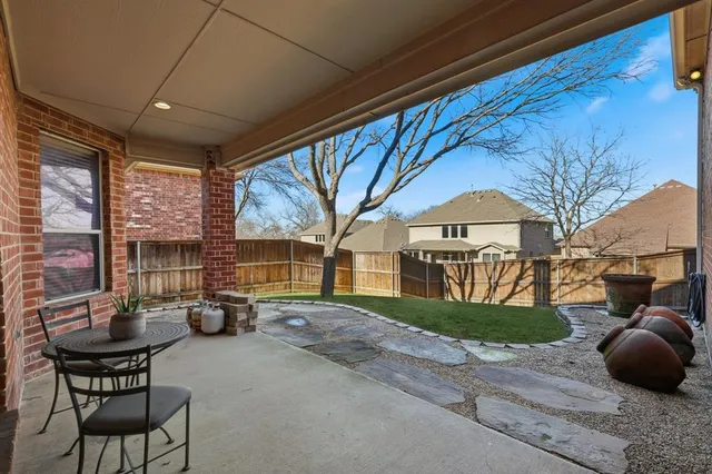 a view of a porch with furniture and a yard