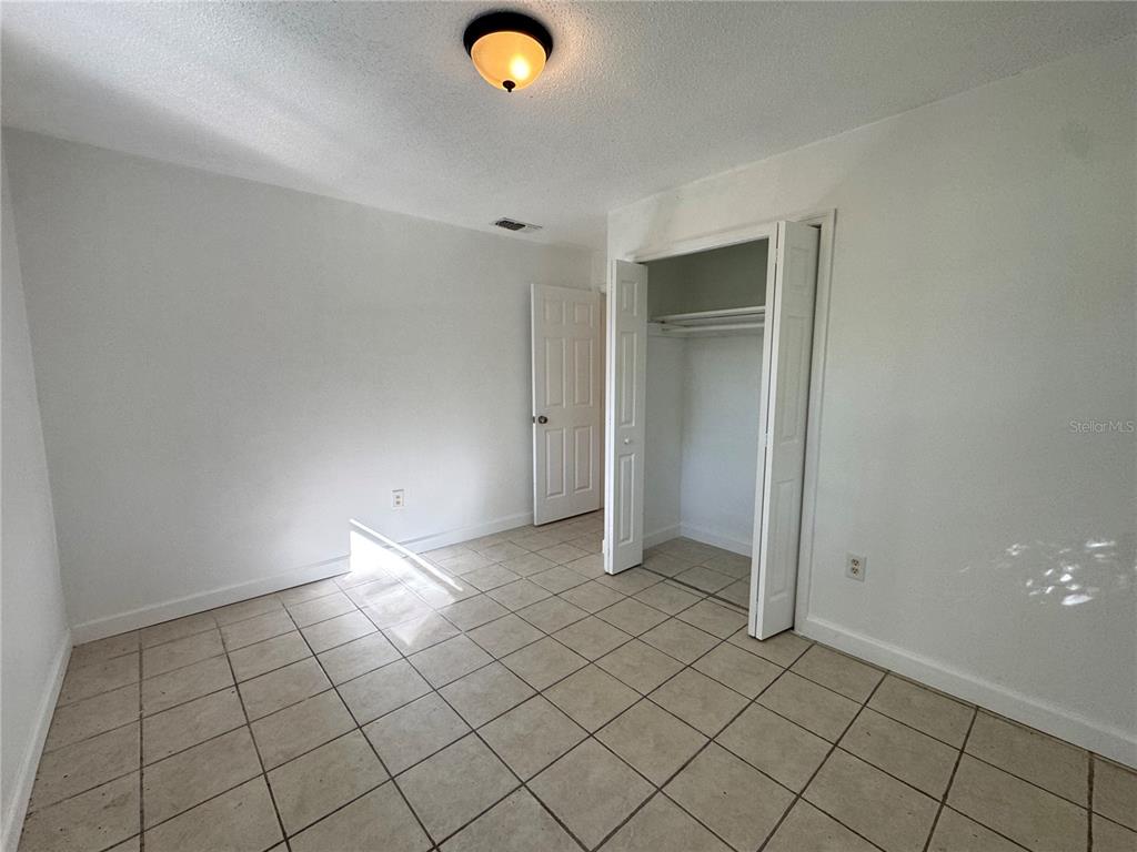 4883 North Pine Hills Road, Unit 4881 Orlando, FL 32808 - Photo 11 of 16 an empty room and closet