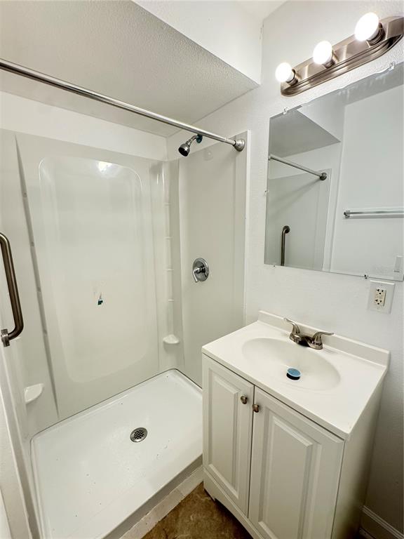 4883 North Pine Hills Road, Unit 4881 Orlando, FL 32808 - Photo 14 of 16 a bathroom with a sink a tub and a mirror