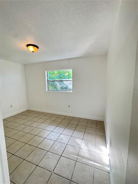 4883 North Pine Hills Road, Unit 4881 Orlando, FL 32808 - Photo 10 of 16 an empty room with windows