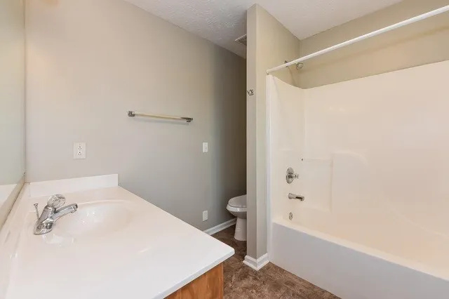 a bathroom with a bathtub and a toilet