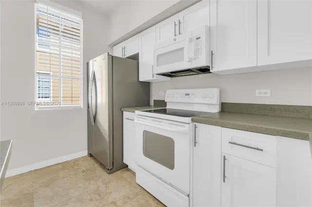 a kitchen with granite countertop a sink and cabinets