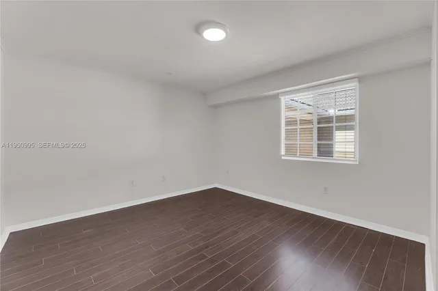 a view of wooden floor and windows in a room