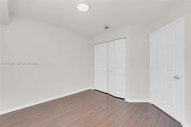 a view of an empty room and wooden floor