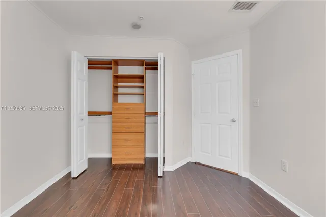 a bathroom with a sink a toilet a mirror and shower