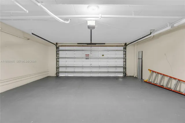 a view of a room with gym equipment and refrigerator