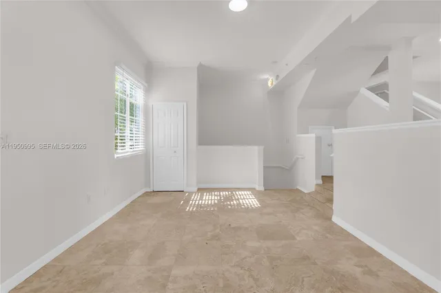 a view of a kitchen with wooden floor and stairs