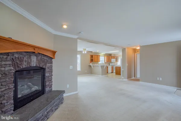 a view of empty room with a fireplace