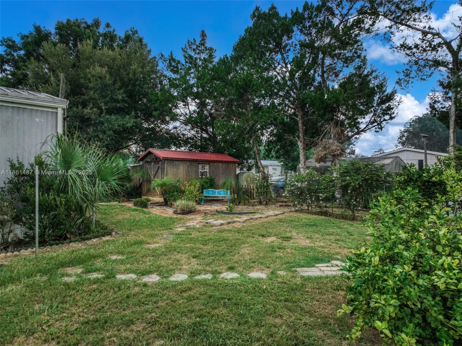 1145 Bluejay Road Wauchula, FL 33873 - Photo 29 of 42 a view of a house with a yard and sitting area