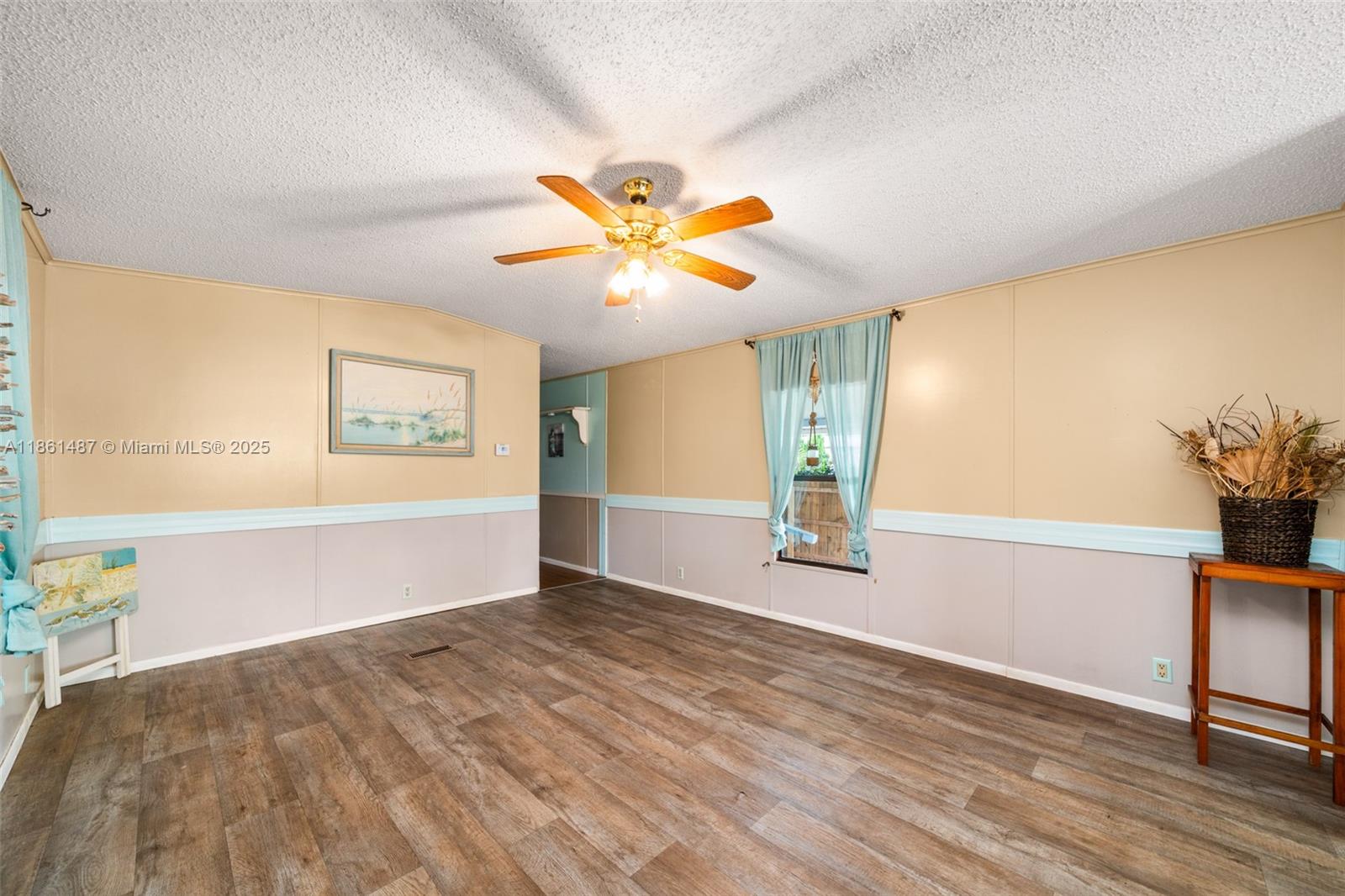 1145 Bluejay Road Wauchula, FL 33873 - Photo 4 of 42 a view of a big room with wooden floor and a chandelier fan