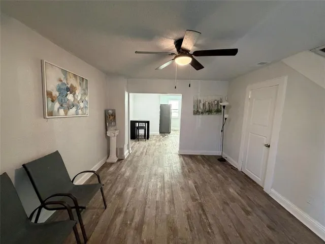 a view of a livingroom with furniture and a ceiling fan