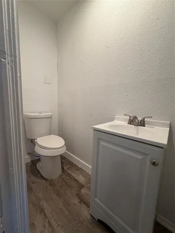 a bathroom with a sink toilet and a mirror