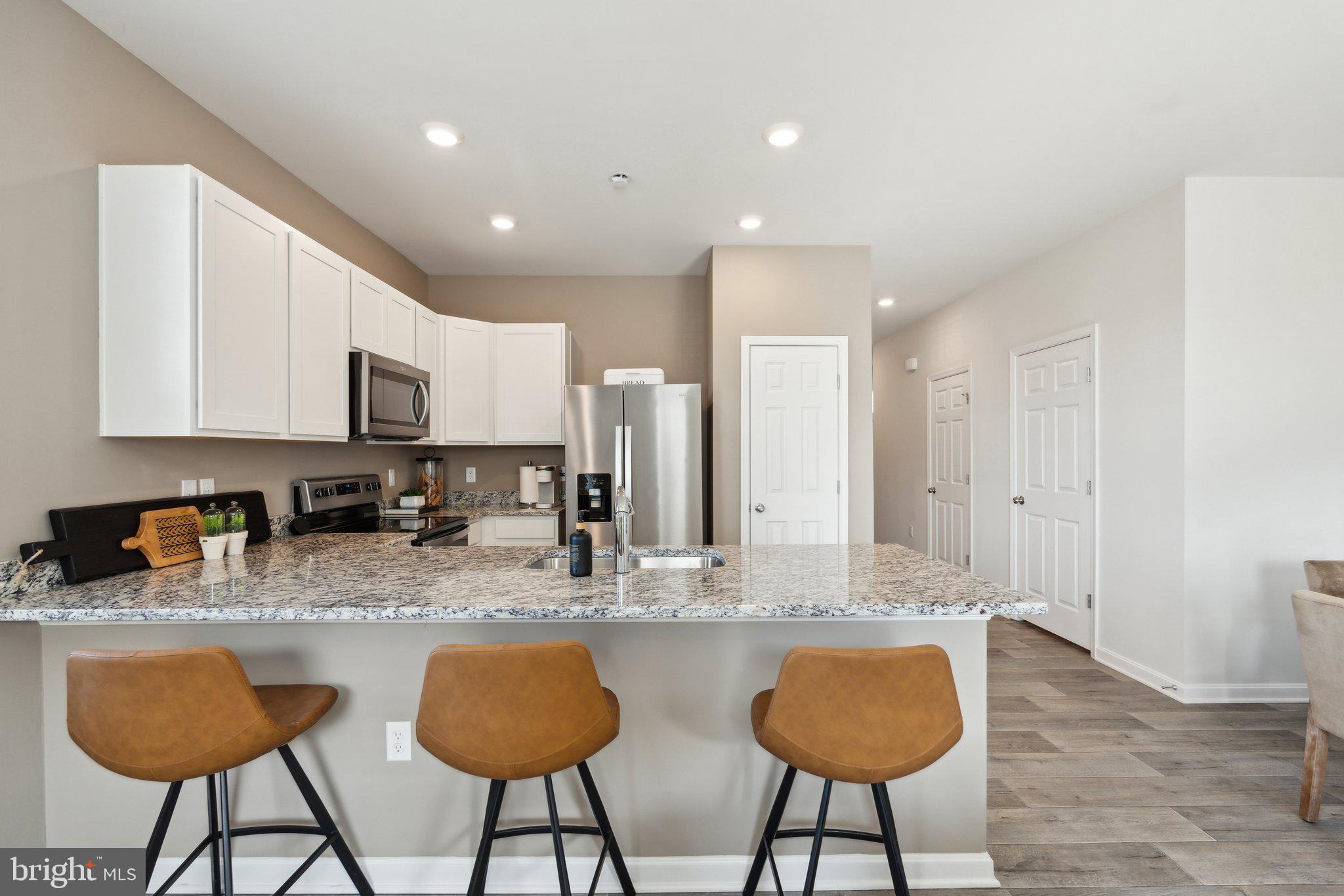 163 Rae Court Luray, VA 22835 - Photo 8 of 31 a kitchen with stainless steel appliances granite countertop a table chairs sink and cabinets