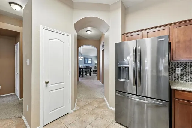 a metallic refrigerator freezer sitting in a kitchen
