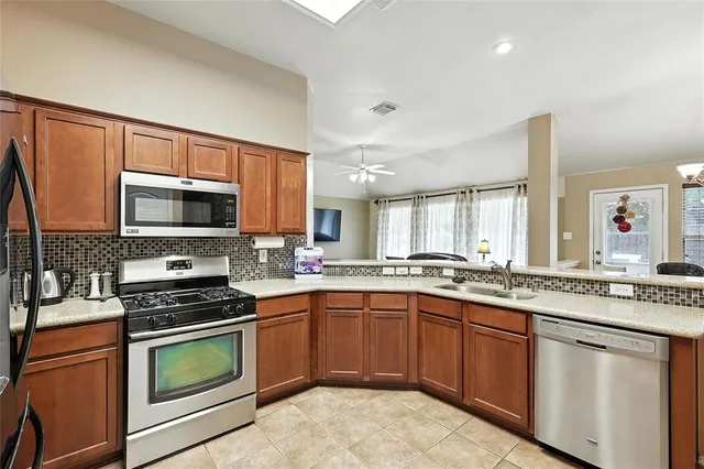 a kitchen with a sink stove and microwave