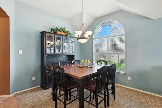a view of a dining room with furniture and window