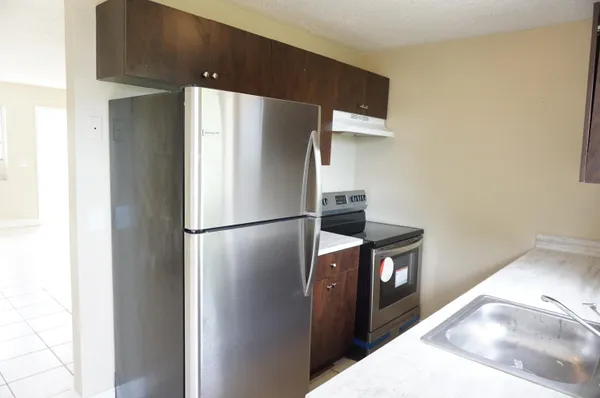 a kitchen with stainless steel appliances a refrigerator and a stove