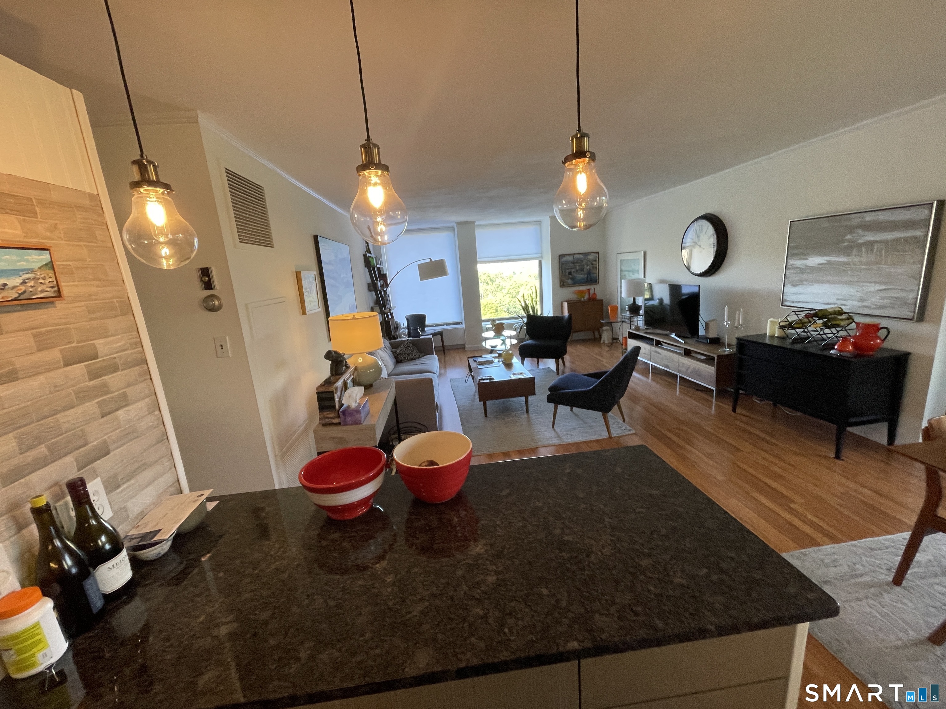 1 Gold Street, Unit 9C Hartford, CT 06103 - Photo 6 of 16 a living room with furniture a chandelier and a fireplace