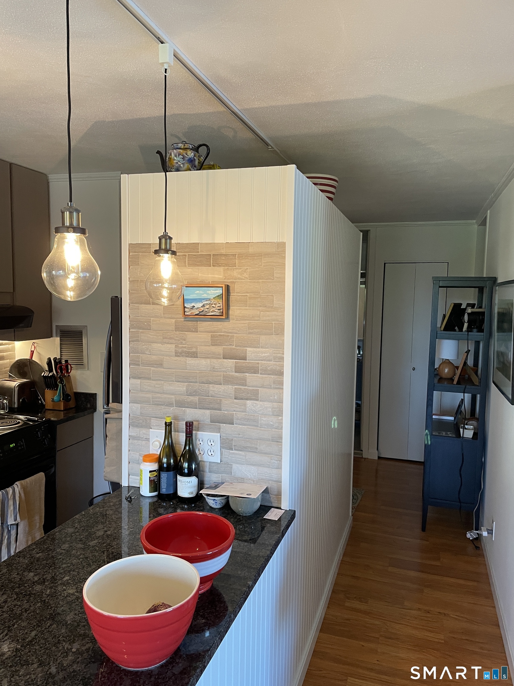 1 Gold Street, Unit 9C Hartford, CT 06103 - Photo 7 of 16 a kitchen with a refrigerator and chairs