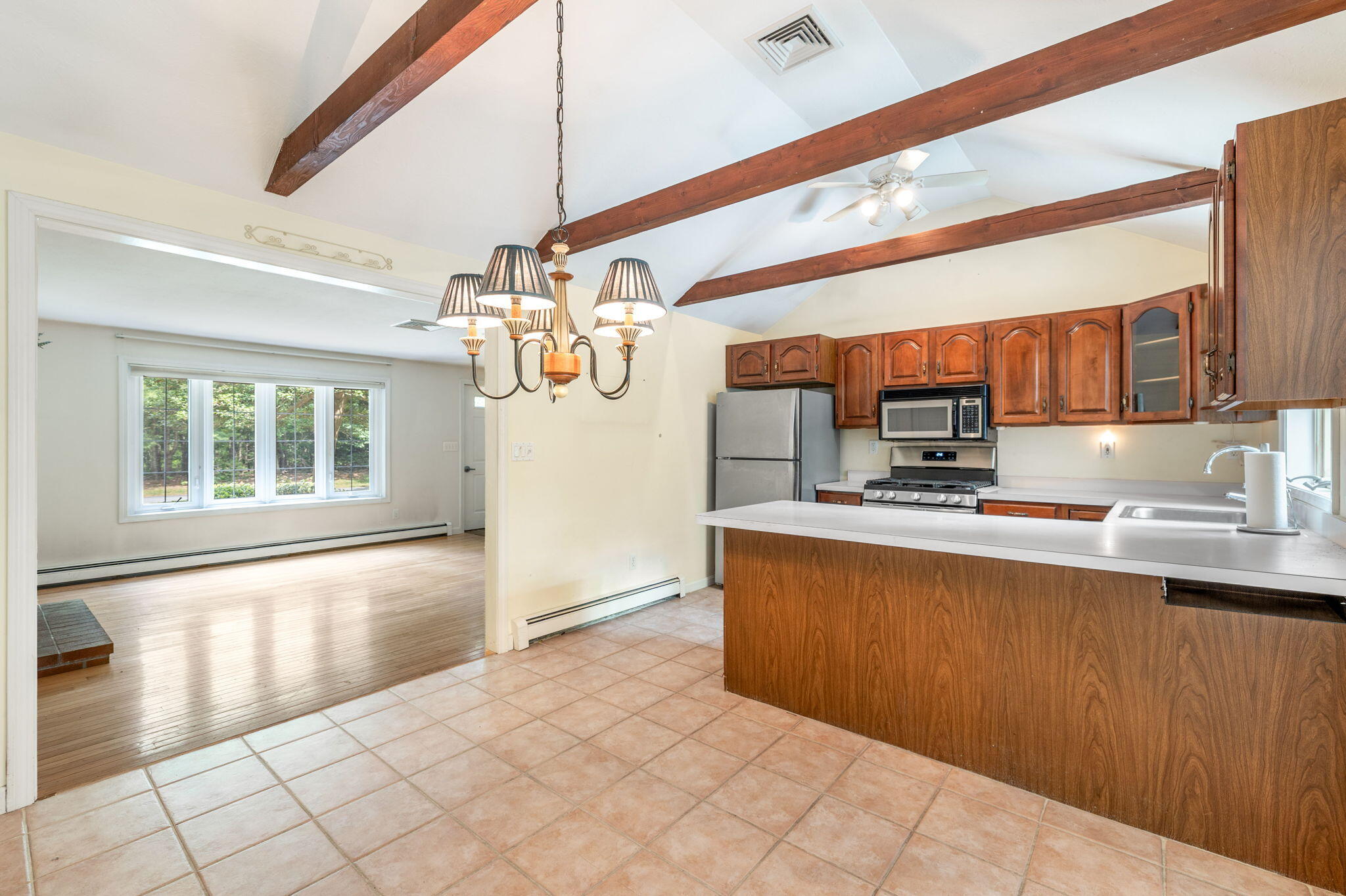 66 Chuckles Way Marstons Mills, MA 02648 - Photo 12 of 32 a kitchen with stainless steel appliances a sink stove and refrigerator