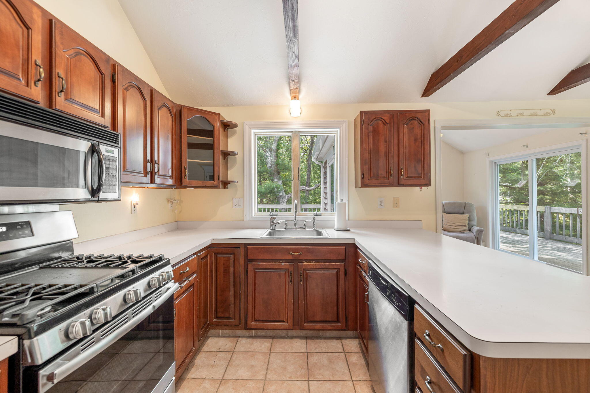 66 Chuckles Way Marstons Mills, MA 02648 - Photo 14 of 32 a kitchen with stainless steel appliances a sink stove and cabinets
