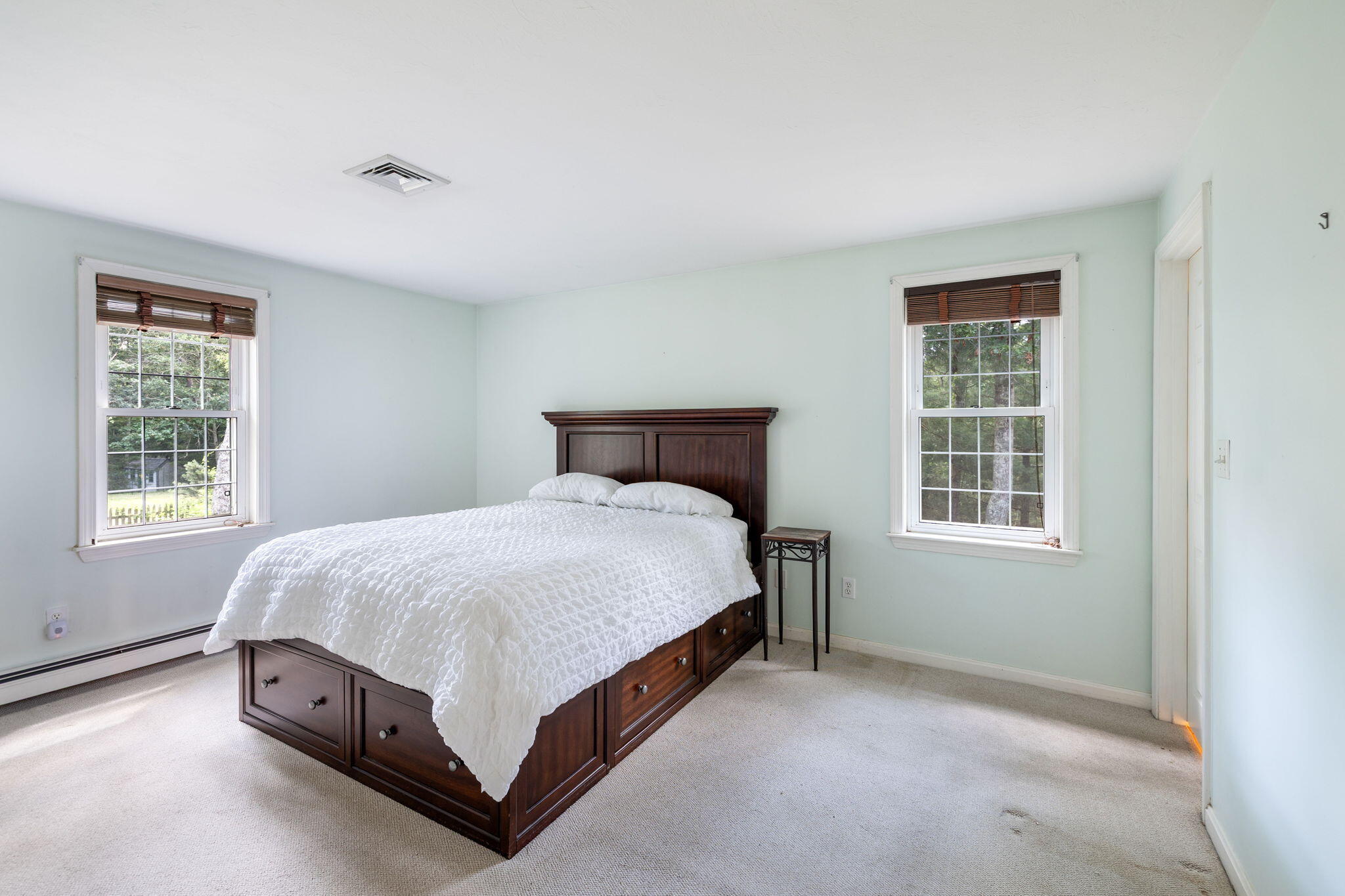66 Chuckles Way Marstons Mills, MA 02648 - Photo 20 of 32 a bed sitting in a bedroom next to a window