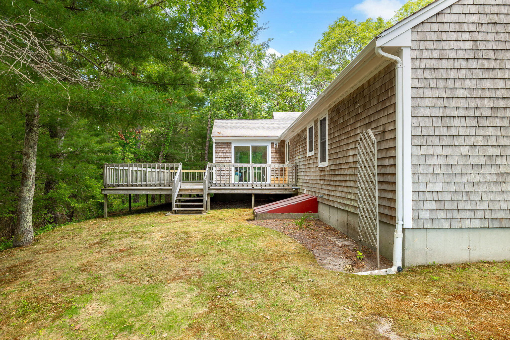 66 Chuckles Way Marstons Mills, MA 02648 - Photo 28 of 32 a view of a house with backyard and sitting area