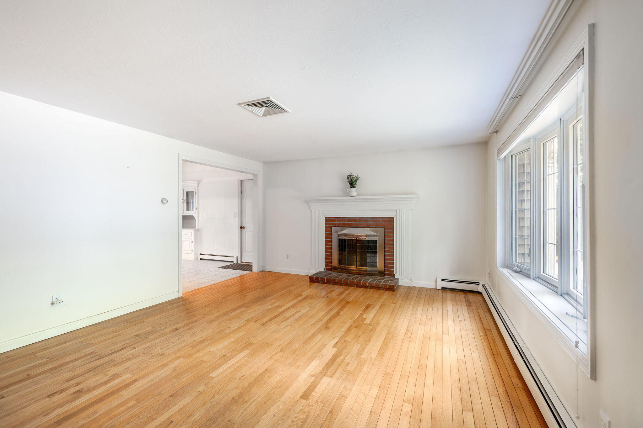 66 Chuckles Way Marstons Mills, MA 02648 - Photo 6 of 32 a view of empty room with wooden floor and fireplace