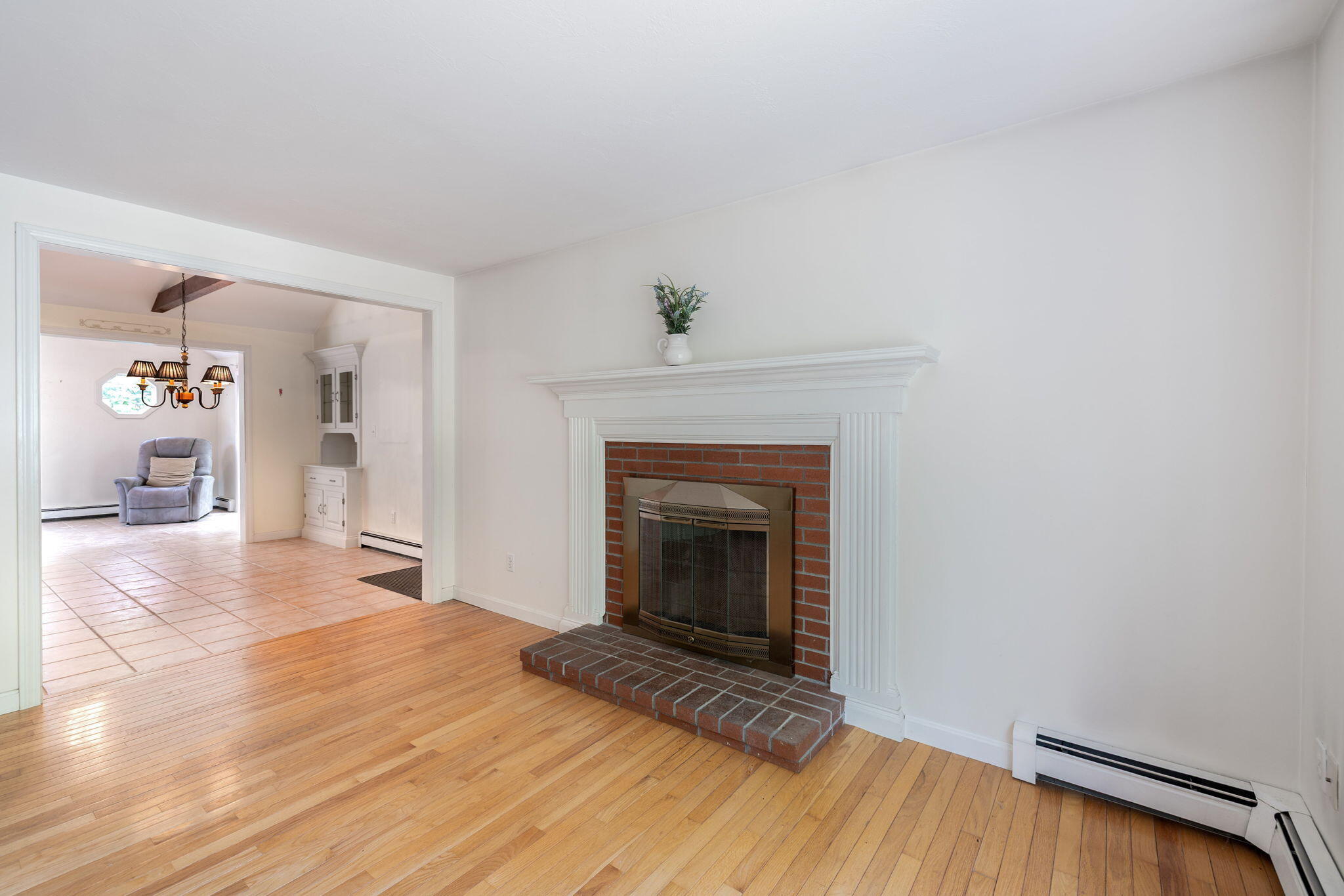 66 Chuckles Way Marstons Mills, MA 02648 - Photo 7 of 32 a view of a livingroom with wooden floor and a fireplace