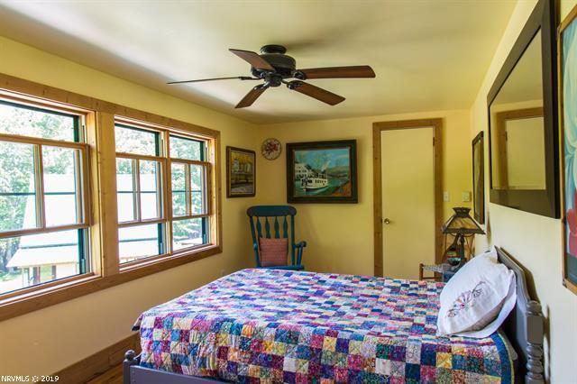 2094 Union School Road Southwest Willis, VA 24380 - Photo 11 of 40 a bedroom with a bed and a window