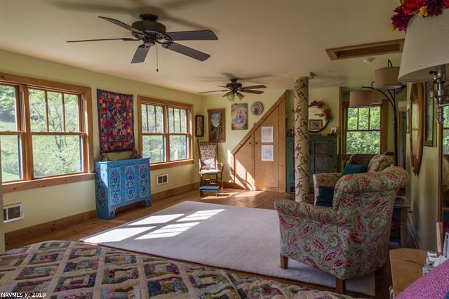 2094 Union School Road Southwest Willis, VA 24380 - Photo 14 of 40 a living room with furniture gym equipment and a window